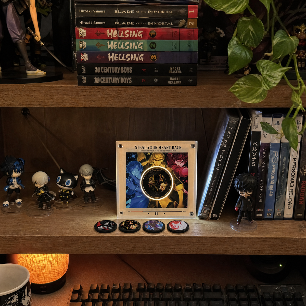 Vinyl player displayed on a collector's shelf with manga and games